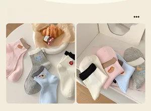 Close-up of summer cotton socks with cute animal embroidery and ribbed texture knit