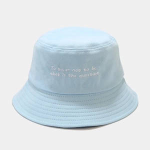 Detailed view of light blue bucket hat with white Shakespearean quote embroidery