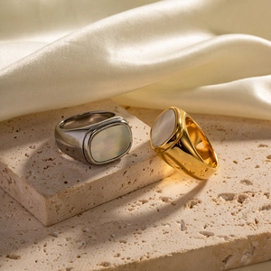 Rectangle white shell rings in 18K gold and silver stainless steel on stone