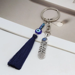 Evil eye keychain with blue tassel and silver feather charm for handbag accessory