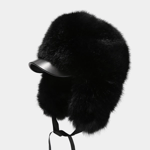 Detailed view of the black faux fur trapper hat with leather brim and long plush texture