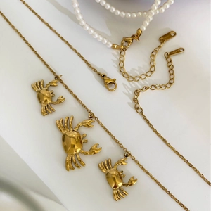 Gold stainless steel crab pendant necklace with pearl accents in a layered design
