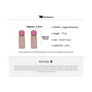 Detail view of pink gemstone earrings with red rhinestone tassels and dimension specs