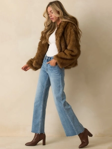 Brown faux fur jacket styled with blue jeans and brown leather ankle boots