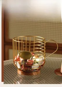 Detail of gold metal wire coffee pod basket with wood base and COFFEE label