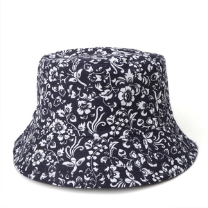 Close-up of reversible cotton sun hat featuring white floral prints on dark blue fabric
