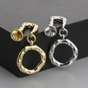 Close-up of irregular hammered texture hoop earrings in gold and silver finish