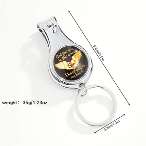 Memorial nail clipper keychain with winged heart and son tribute on white background