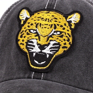 Detailed close-up of premium leopard head embroidery on dark gray washed cotton baseball cap
