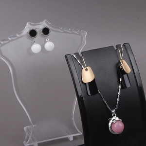 Plastic jewelry display stand with dolphin pendant necklace and pearl earrings