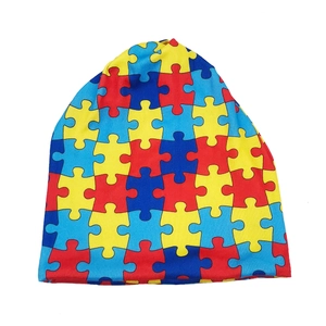 Detailed view of knitting texture and colorful jigsaw puzzle pattern on the beanie hat