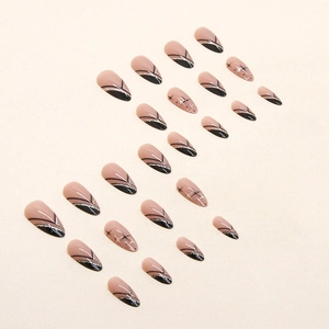 Almond press-on nails with black French tips, silver glitter lines, and star patterns