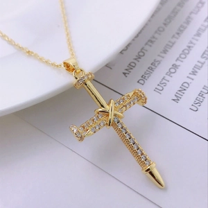 Detailed macro view of a 14K gold-plated cross pendant featuring pave-set cubic zirconia
