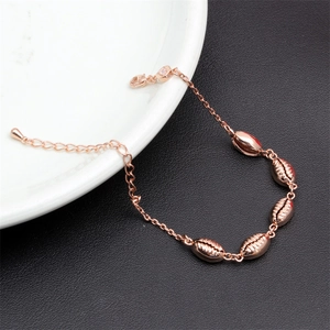 Minimalist bohemian shell charm bracelet in rose gold plating with adjustable chain