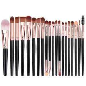 Close-up of 21 professional makeup brushes with black handles and rose gold ferrules