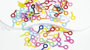 Macro shot of colorful assorted eye pin screws for DIY jewelry making and keychains