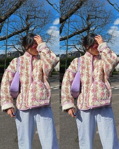 Close-up of floral quilted jacket with retro padding, stand collar, and pocket detail