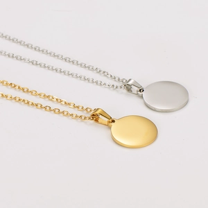 Polished gold and silver disc pendants with Christmas magic engraving on O-chains