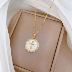 Luxury gold titanium cross necklace with shimmering white stones and mother of pearl detail