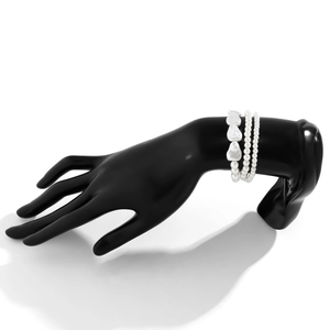 Detailed view of baroque pearl bracelets set on a black display model with elegant texture