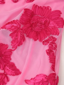 Close-up of intricate deep pink 3D flower embroidery on premium pink mesh fabric