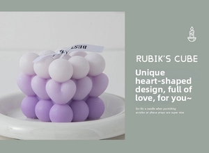 Detailed view of purple gradient Rubik's cube candle with heart-shaped bubbles and ribbon
