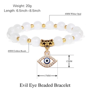 Pink zebra stone bracelet with evil eye charm and dimensional specs on white background