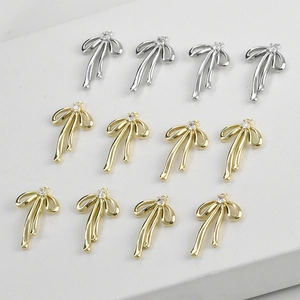 Polished gold and silver ribbon bow charms with inlaid diamonds for DIY jewelry making