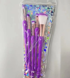 Detail view of 5-piece purple mermaid makeup brush set in holographic packaging