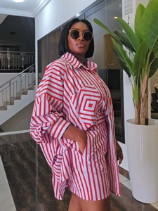 Detail of red and white striped oversized shirt and shorts set on a standing model