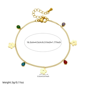 Gold chain bracelet featuring colorful teardrop gems and floral charms on a white background