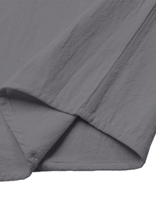 Detailed close-up of double-stitched hem and textured dark grey cotton linen fabric