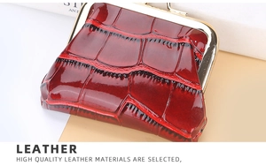 Macro shot of dark red glossy crocodile texture coin purse with gold metal clasp closure