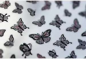 Detailed macro of 5D textured butterfly nail stickers with purple gradient wing patterns