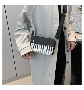 Detail of music-themed camera bag with piano key pattern and I LOVE MUSIC print