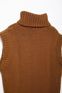 Detail shot of caramel brown knitted sweater vest showing the thick fabric texture