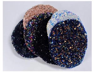 Multiple colors of sequin beret hats including pink black and blue shown in a stack