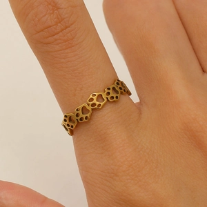 Detail of cute gold-plated cat paw cutout design on a stainless steel open ring