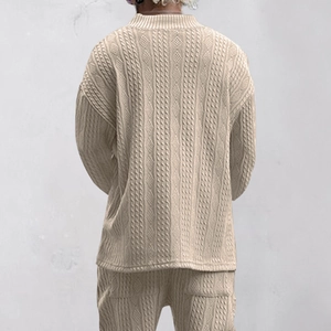Close-up of beige men's knitwear showing 3D cable texture and v-neck sweater back detail
