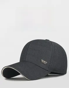 Detail of dark gray baseball cap with metal SPORTS STYLE emblem and sandwich brim