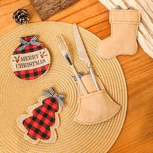 Festive Christmas cutlery holders on woven placemat with Merry Christmas embroidery detail