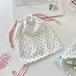 Detail of polka dot drawstring storage pouch with SOZAKKA label and woven pink cord