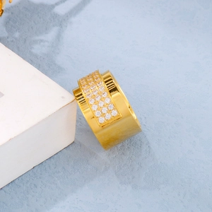 Detailed close-up of wide gold-plated band ring with triple-row micro-pave white cubic zirconia