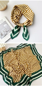 Detail of green geometric silk scarf tied and flat layout with luxury patterns
