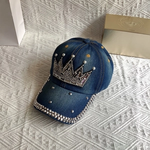 Detailed view of denim baseball cap featuring crown rhinestone and pearl decorations