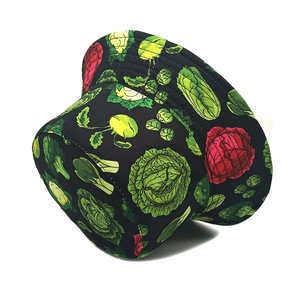 Detailed close-up of vibrant vegetable patterns on black cotton bucket hat
