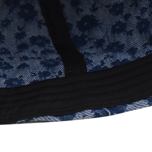 Macro view of blue floral denim baseball cap interior stitching and black webbing details