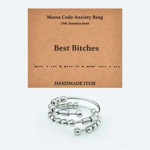 Detail of Morse Code fidget ring with movable beads on a handmade display card