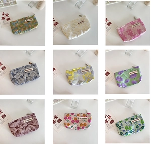 Detail of nine floral quilted makeup bags with embossed patterns and metal zippers