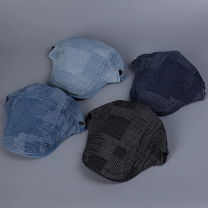 Detailed overhead view of denim newsboy caps in four shades of blue and black denim